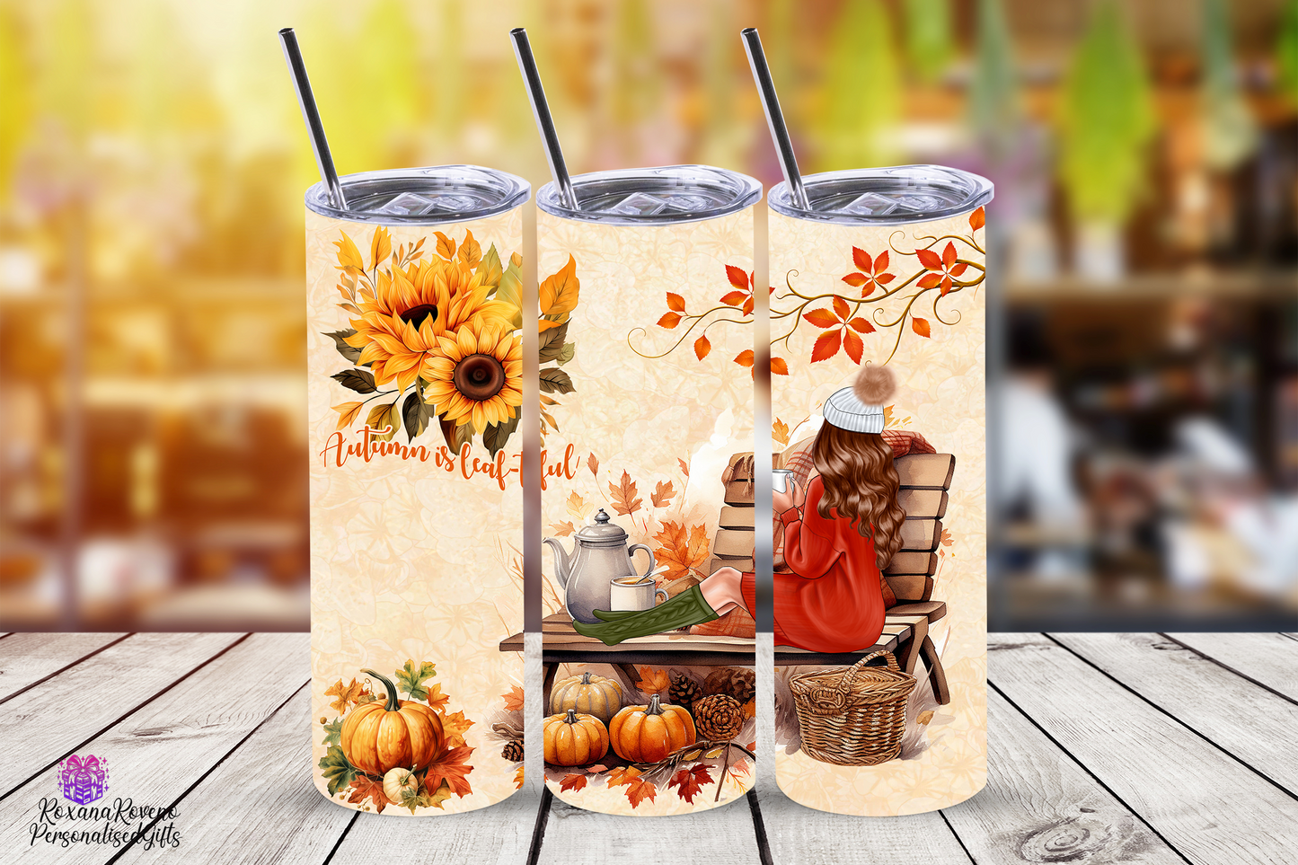 Three autumn-themed tumblers with sunflowers, pumpkins, and a person reading a book on a bench.