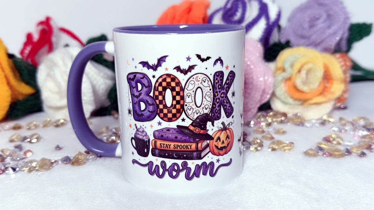 Book Worm Halloween book lover mug with purple handle and spooky book design