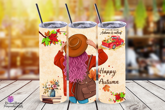 Three autumn-themed tumblers with designs of a person in a coat, a hat, and a truck, on a wooden surface.