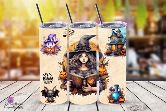 Three Halloween-themed tumblers with illustrations on a wooden surface.
