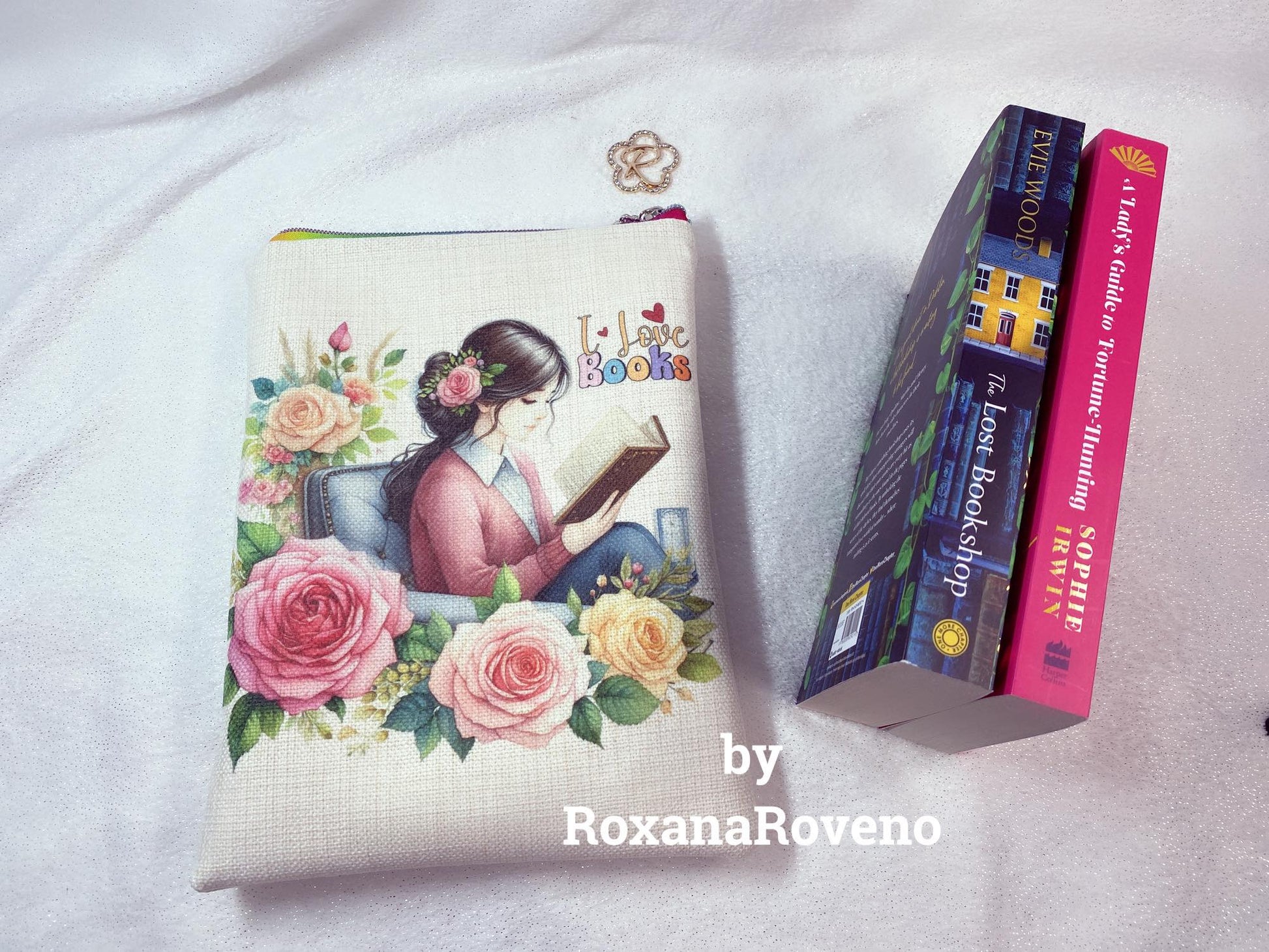 handmade book sleeve designed by roxana roveno one side with a girl reading between flowers and quote 'I Love Books' fit two small books