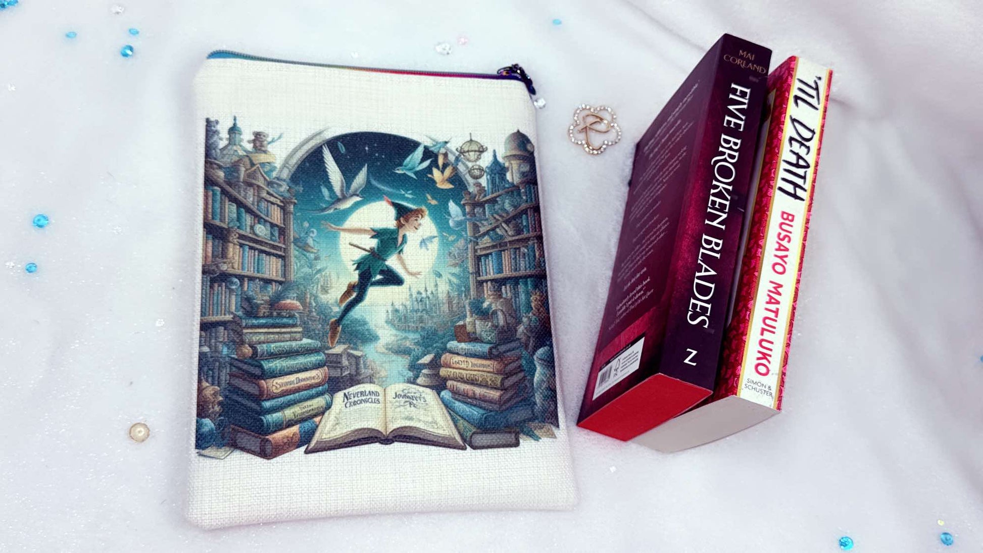 Personalised book sleeve handmade by Roxana Roveno with a special design inspired by classic stories Peter Pan flying between books front side, perfect fit for 'five broken blades' and 'til death' books