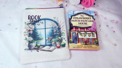 Personalised Handmade book sleeves by RoxanaRoveno perfect gift for a book lovere designed with a rainy window with spring flowers perfect size for book s like 'the strawberry patch pancake house' by Laurie gilmore