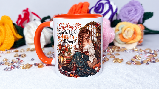 Cozy Pages autumn book lover mug with orange handle and woman reading