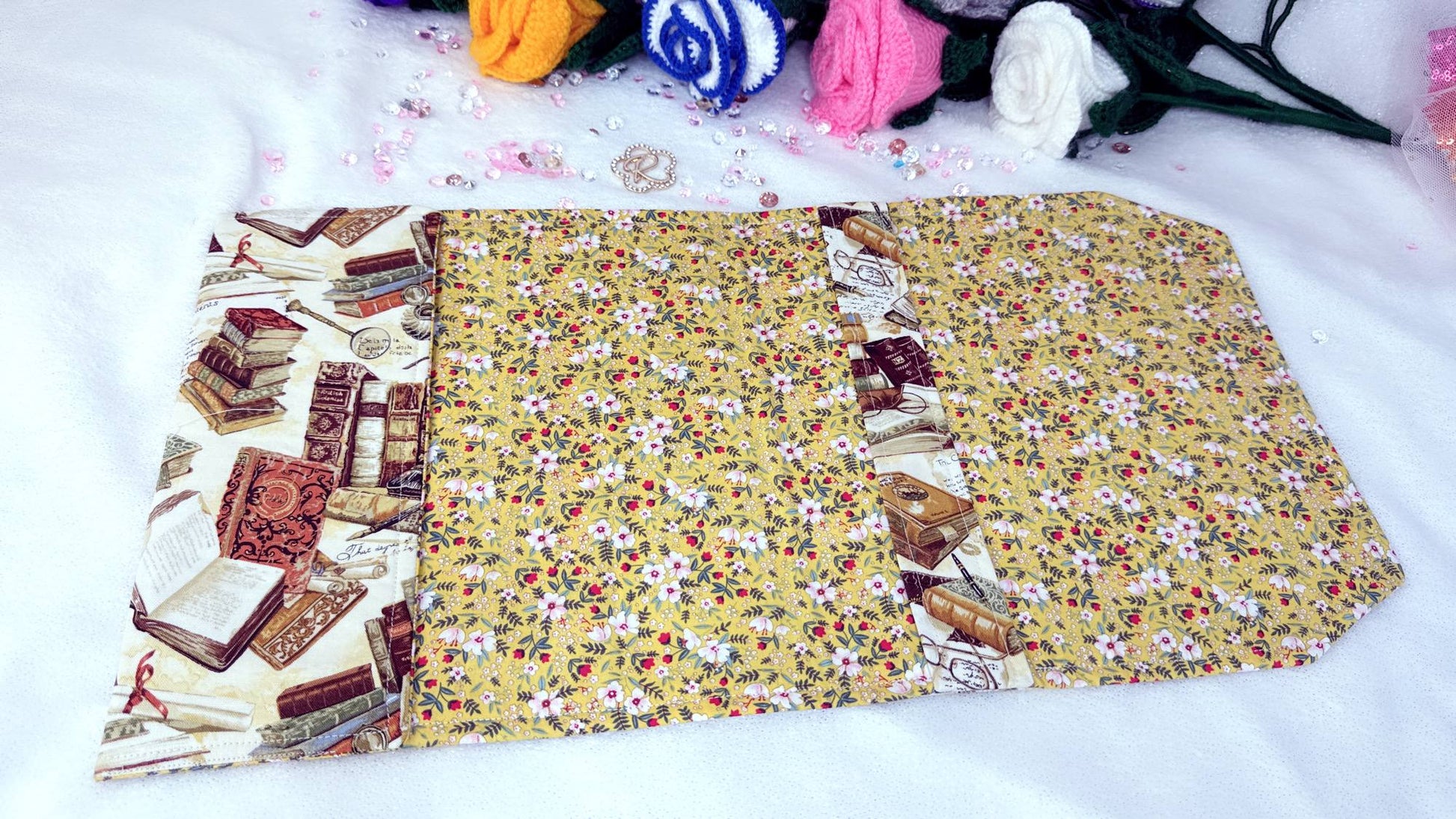 Whether it’s a hardback edition, a slightly larger paperback, or a collector’s piece, this cover provides the perfect balance of protection and elegance.

Crafted from high-quality cotton fabrics with vibrant, coordinated designs, each cover features a durable yet flexible padded lining, keeping your book safe from bent corners, scratches or accidental spills while on the go. yellow flowers nside, handmade by roxana roveno
