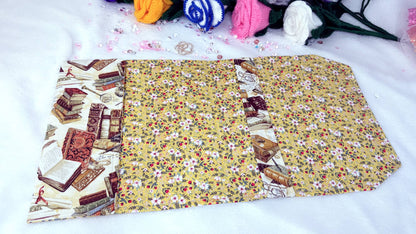 Whether it’s a hardback edition, a slightly larger paperback, or a collector’s piece, this cover provides the perfect balance of protection and elegance.

Crafted from high-quality cotton fabrics with vibrant, coordinated designs, each cover features a durable yet flexible padded lining, keeping your book safe from bent corners, scratches or accidental spills while on the go. yellow flowers nside, handmade by roxana roveno
