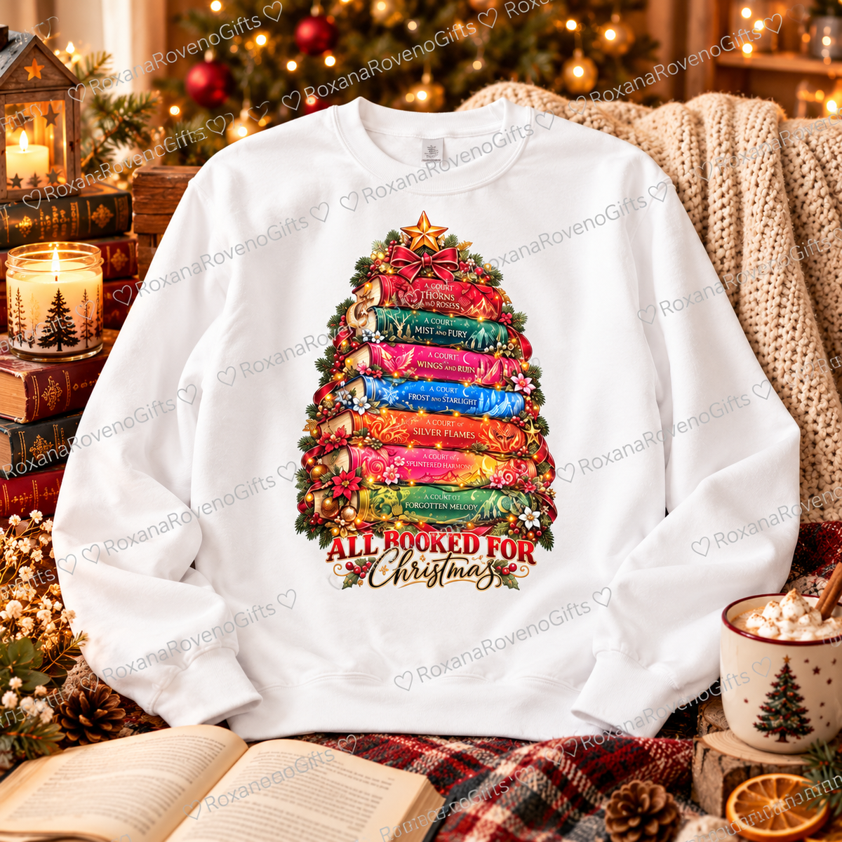 White fleece-lined Christmas sweatshirt with colourful fantasy-inspired books arranged as a festive Christmas tree and All Booked for Christmas lettering, by RoxanaRovenoGifts.