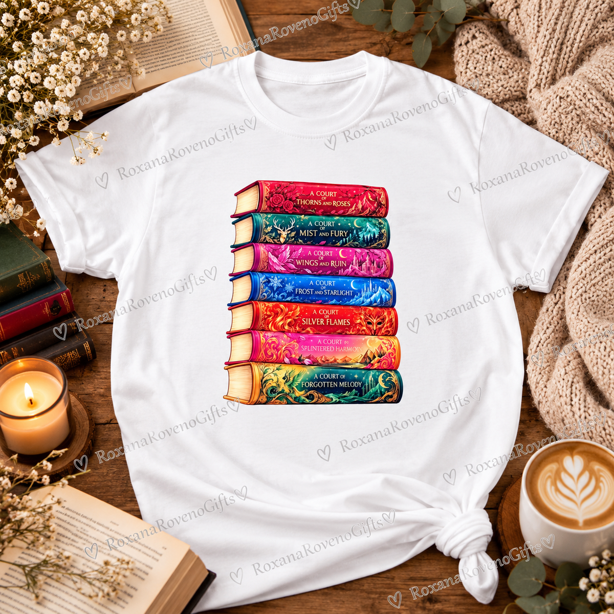 T-Shirt
White 100% cotton T-shirt featuring a colourful ACOTAR-inspired fantasy book stack design, displayed in a cosy bookish setting.
 Copy