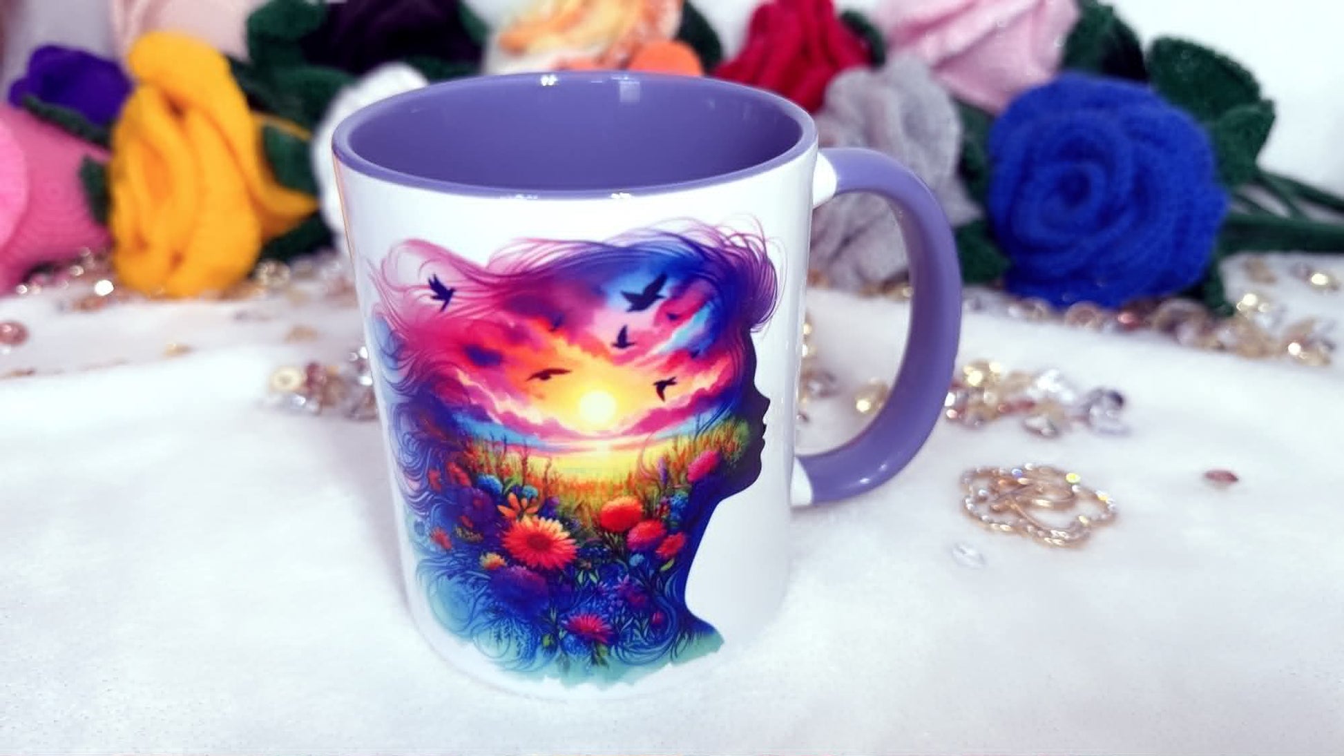 Mug with a colorful design of a face and nature elements on a white surface with flowers in the background. Artistic silhouette mug with colourful floral landscape design, purple handle ceramic mug for book lovers
