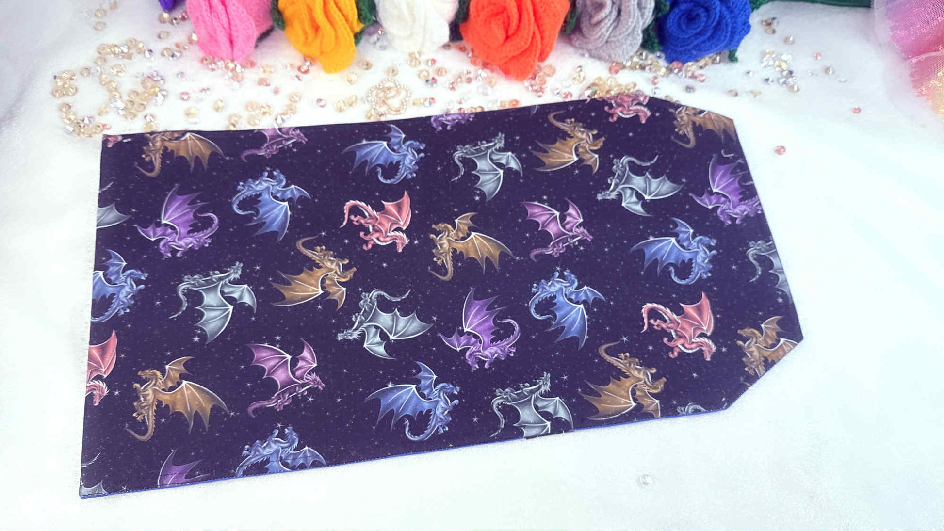 black book cover with colorful dragon pattern on a white surface