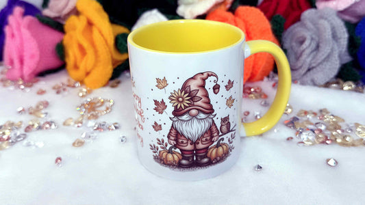 Mug with a gnome design on a white surface with colorful yarn in the background